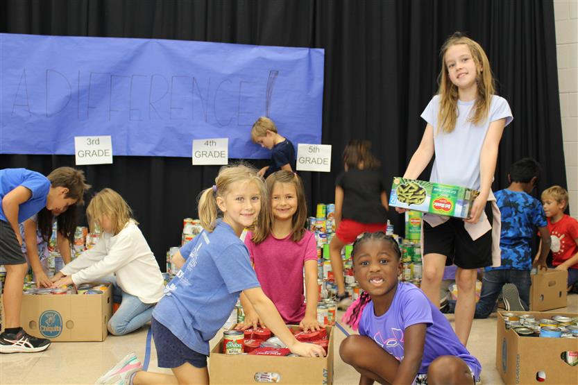 Students collect food for a can drive